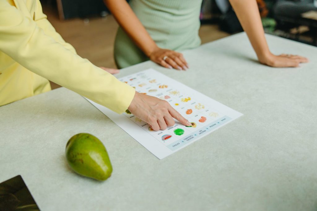 Healthy Food Options Five Diamond Fitness & Wellness Two adults discussing food options with a chart, highlighting healthy nutrition indoors.
